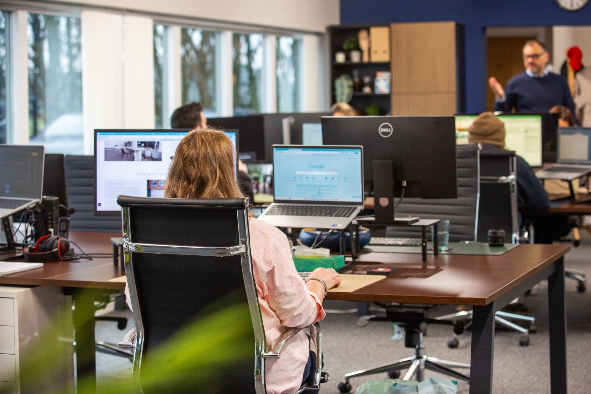 Open-plan office with people working at their desks