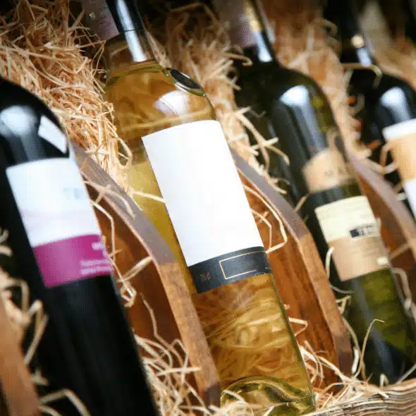 Bottles of red and white wine packed in straw